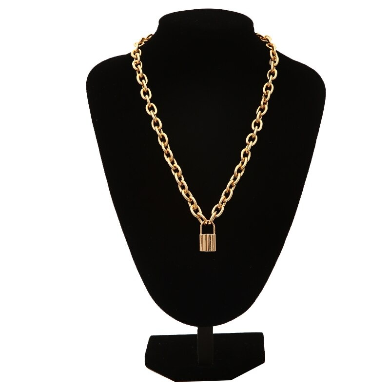 Chunky gold punk chain necklace with a lock pendant displayed on a black stand.