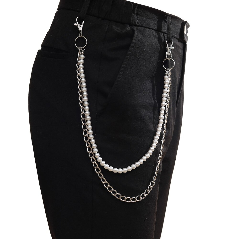Double layer punk chain detail with pearls and silver hooks on black pants for trendy fashion style.