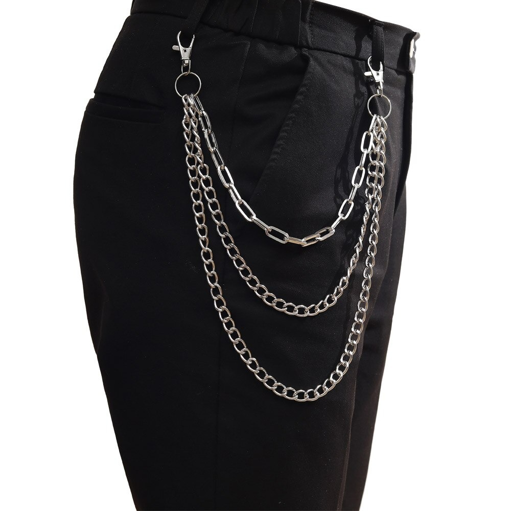 Double layer punk chains hanging on black pants, perfect for adding a trendy touch to any outfit.