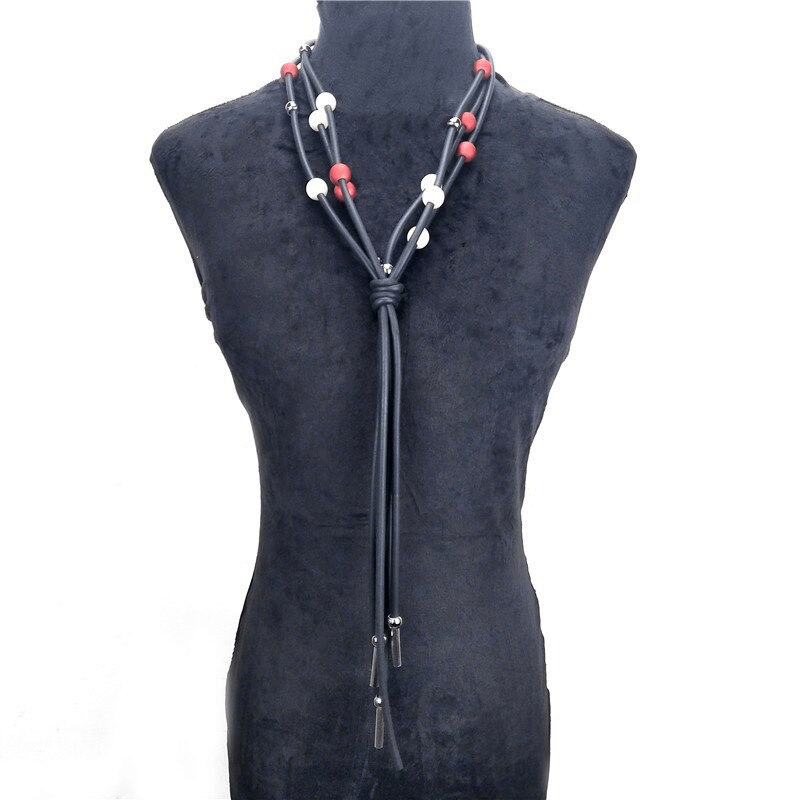 Fashionable red and white pearls long necklace on a stylish display mannequin showcasing luxury women's jewelry.