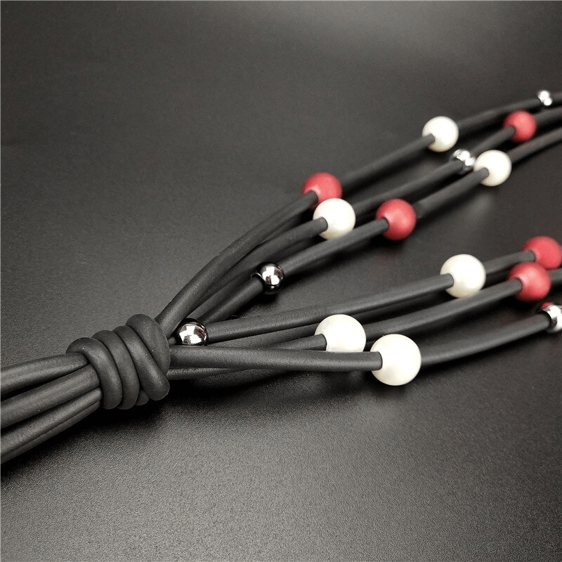 Fashionable red and white pearls long necklace with rubber accents, perfect for adding luxury to casual outfits.