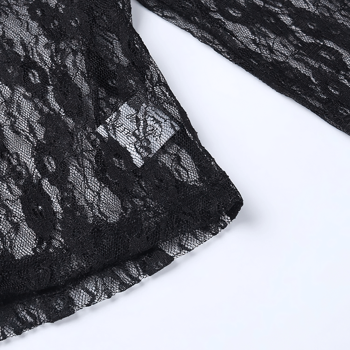 Close-up of a black lace fabric showcasing intricate patterns for a women's gothic crop top.