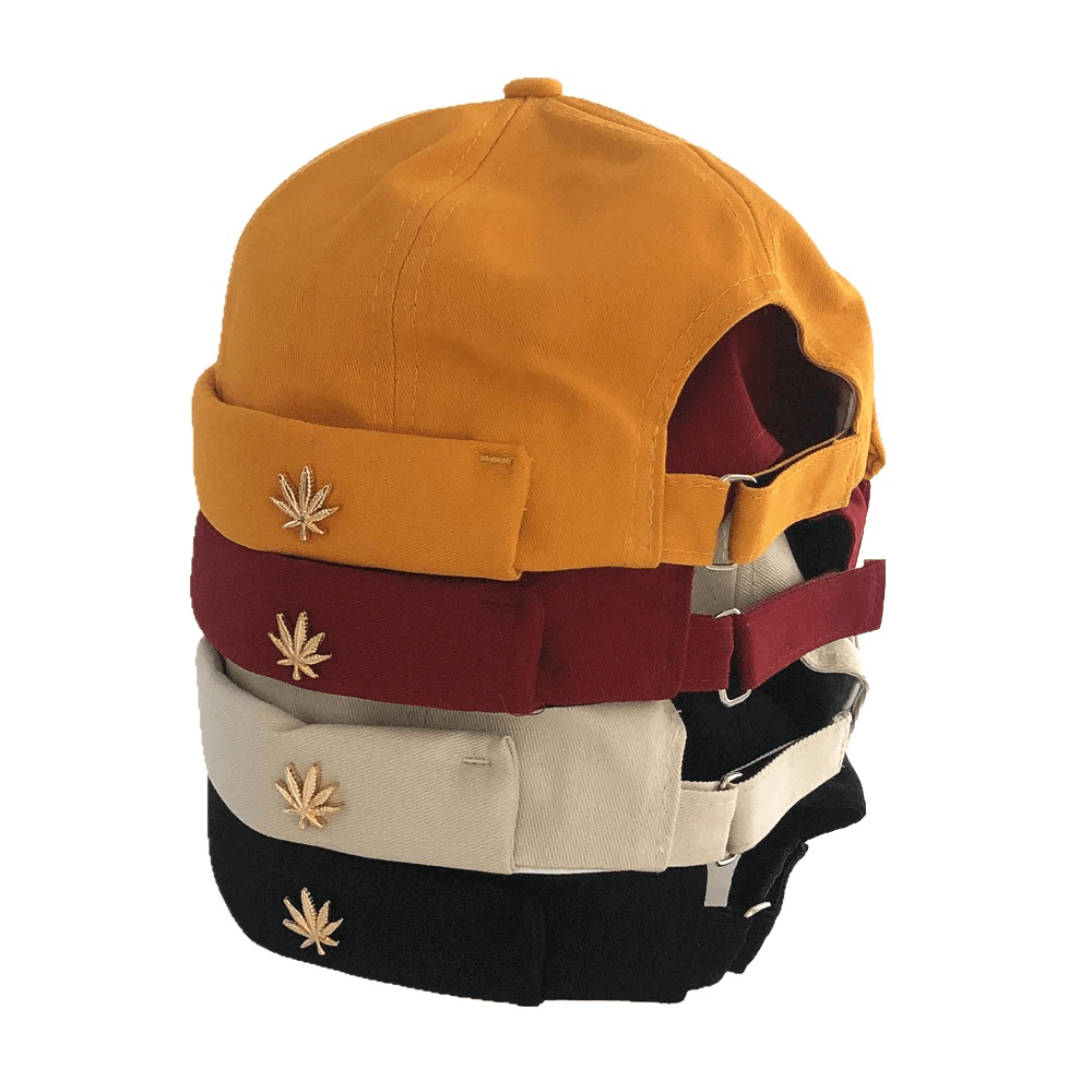 Stylish adjustable brimless caps in assorted colors with leaf rivets, perfect for alternative fashion enthusiasts.