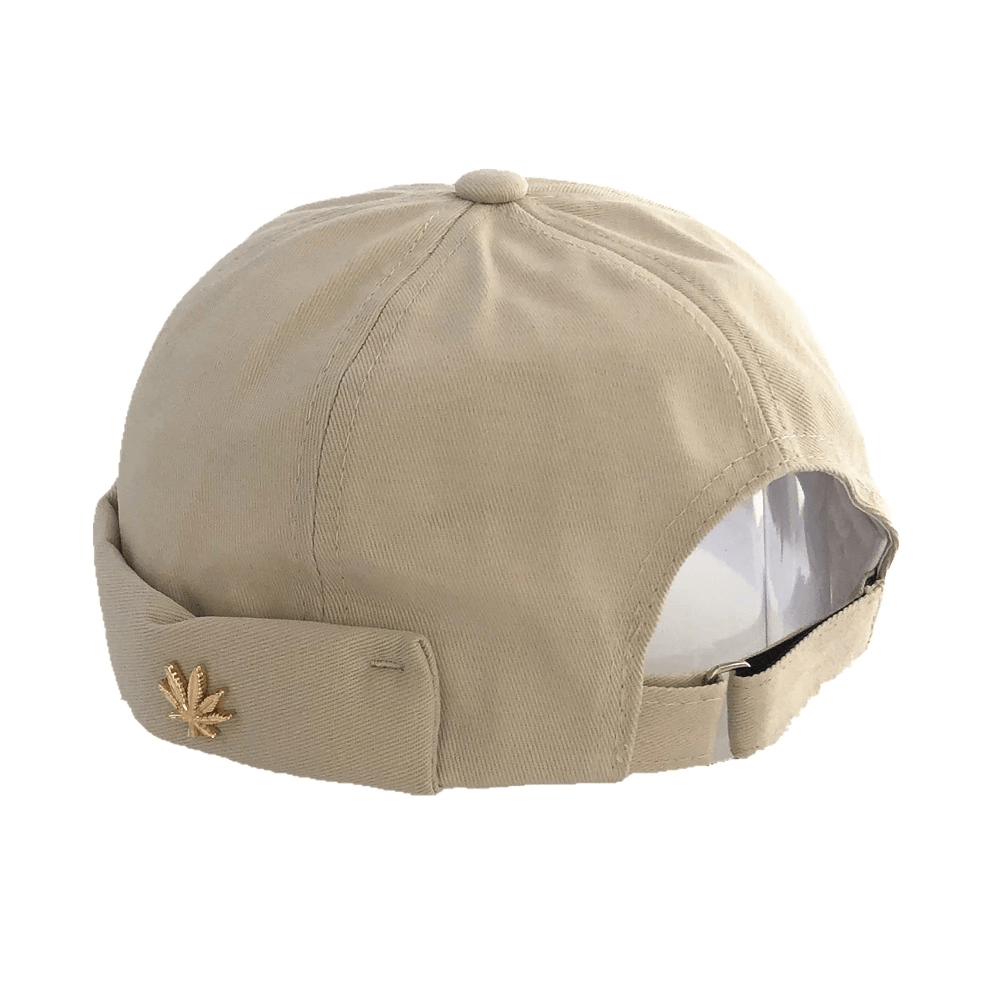 Fashion solid brimless cap in beige with leaf rivet detail, adjustable cotton skullcap for alternative style.