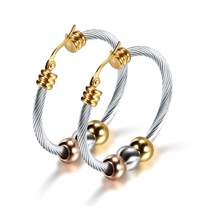 Elegant stainless steel earrings in silver and gold, featuring a twisted design and shiny beads, perfect for trendy outfits.