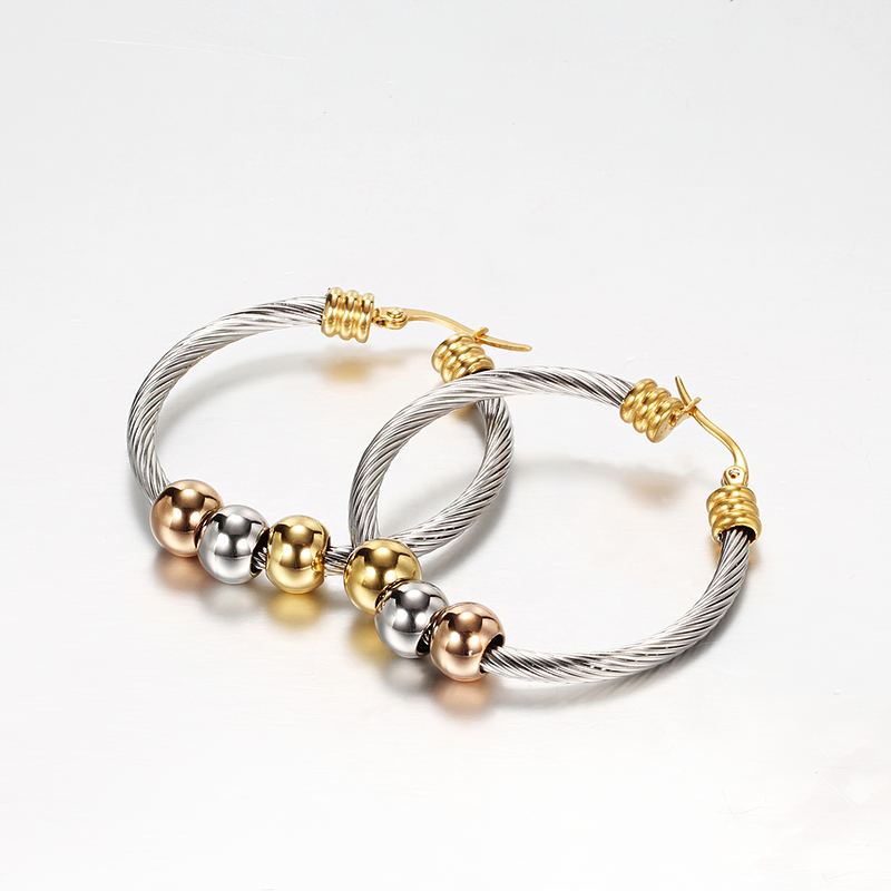Elegant stainless steel hoop earrings with twisted design and shiny beads in silver, gold, and rose gold colors.