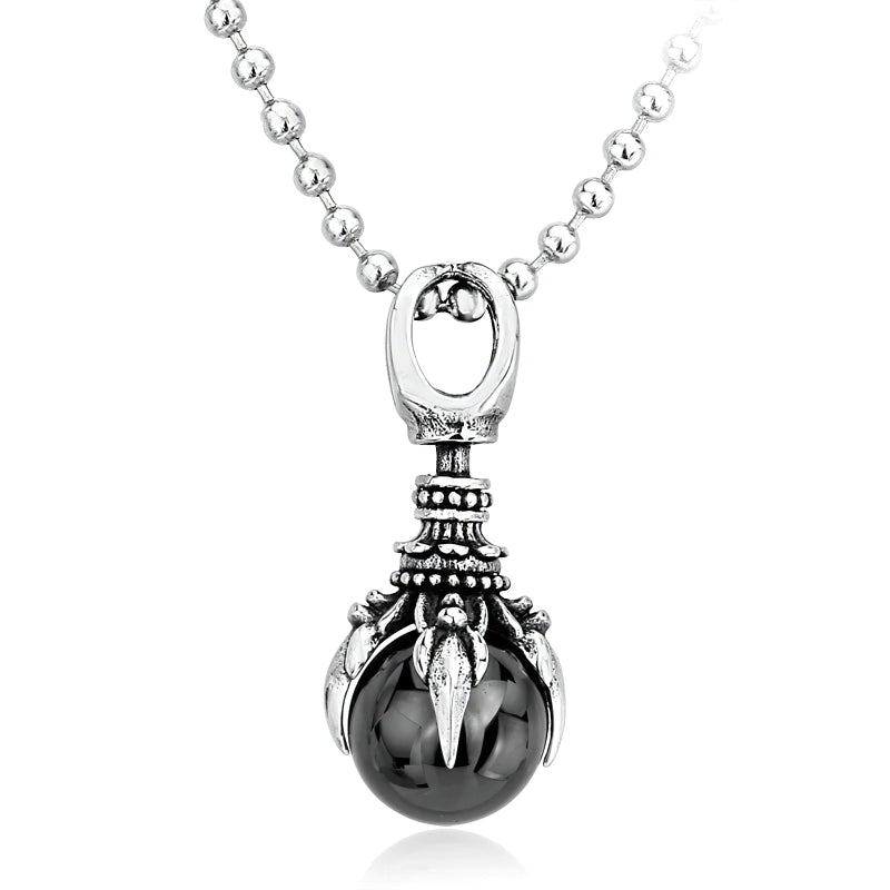 Unisex stainless steel pendant with claw design and black stone, perfect for alternative fashion styles.