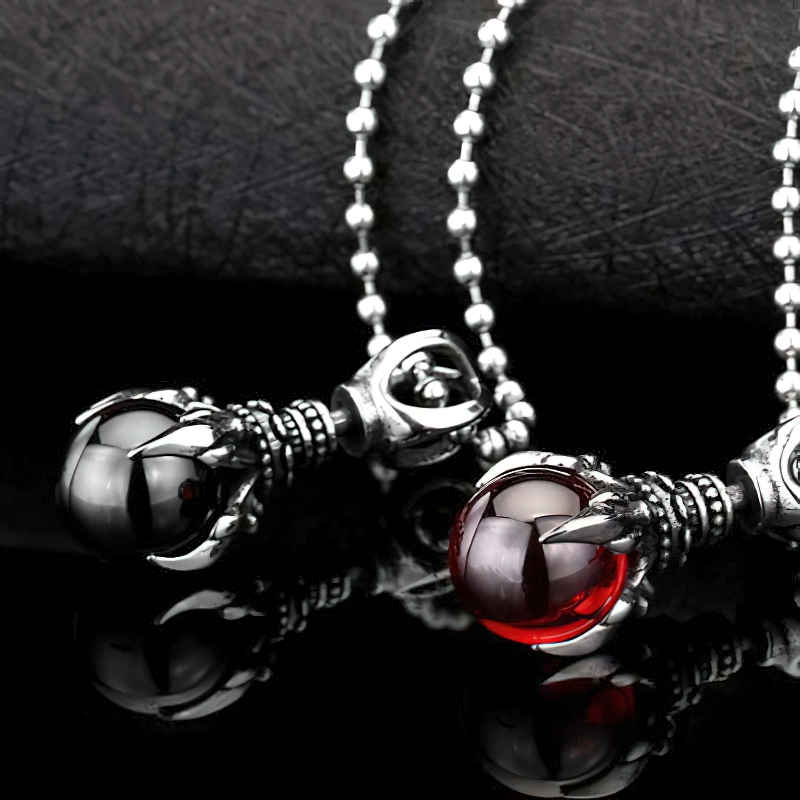 Unisex stainless steel pendants with stone in claw design, featuring red and black stones, perfect for alternative fashion.