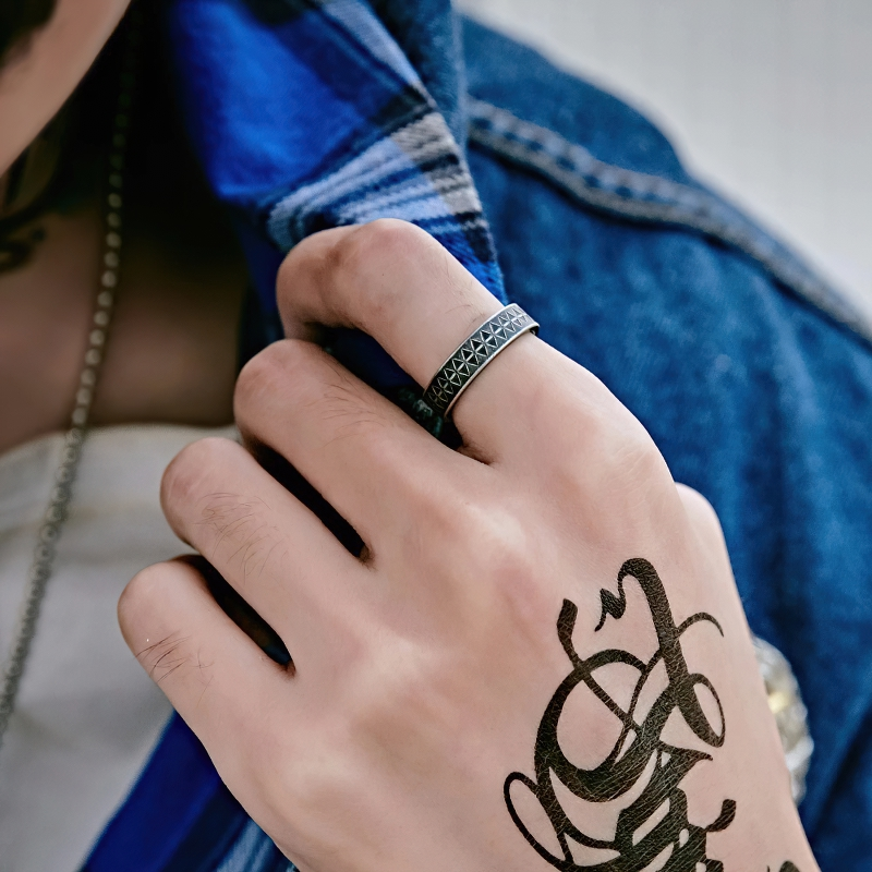 Stylish unisex vintage stainless steel ring with geometric pattern showcased on a hand with a tattoo.