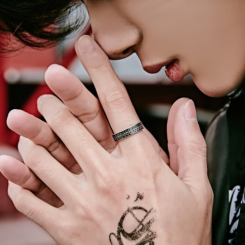 Stylish unisex stainless steel ring with vintage pattern worn on finger, perfect for retro fashion lovers.