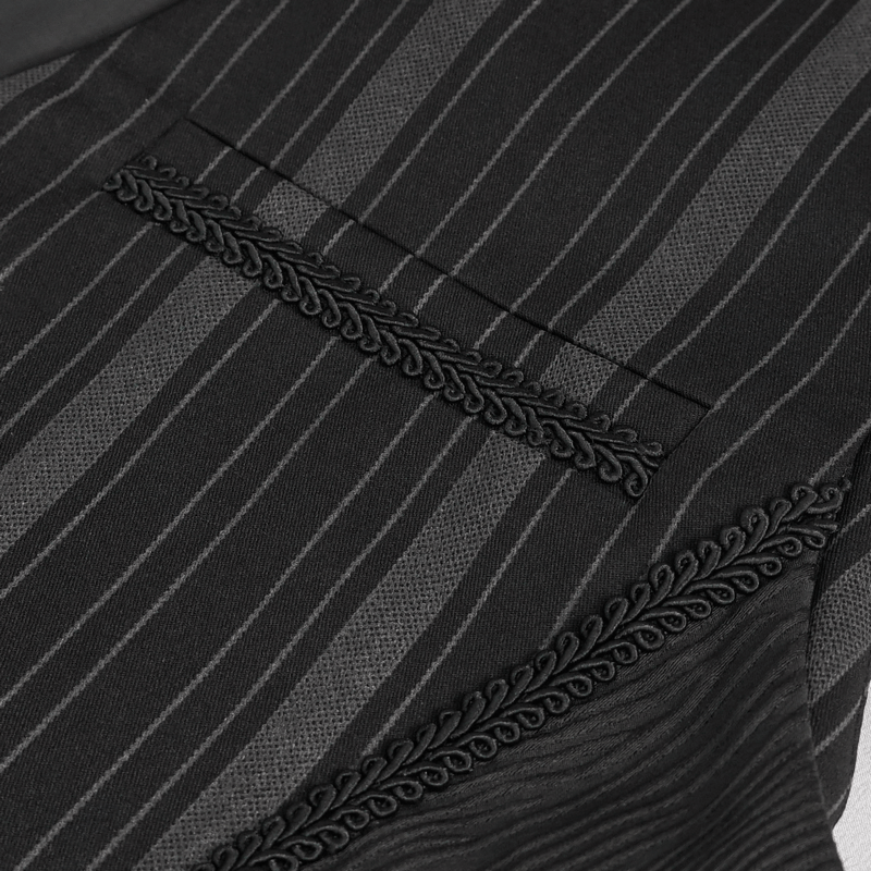 Close-up of black waistcoat fabric showing striped pattern and intricate detailing.