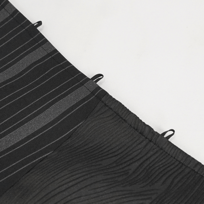 Close-up of a stylish black waistcoat fabric featuring elegant striped patterns and a textured design for gothic fashion.