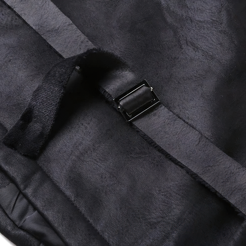 Close-up of black suede fabric with buckle detail from a stylish men's steampunk vest.