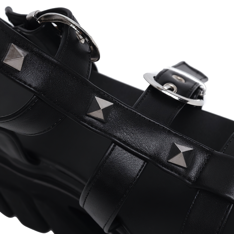 Close-up of black high platform sandals featuring metallic studs and straps for a chic summer look.
