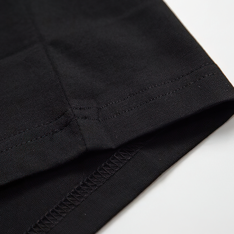 Close-up of the hem of a black T-shirt, highlighting quality stitching and fabric texture, perfect for casual wear.