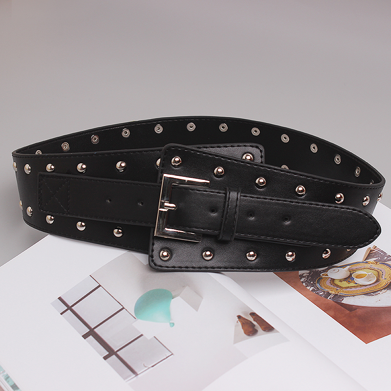 Fashion wide belt for women, decorated with rivets and a metal buckle, made of genuine leather.