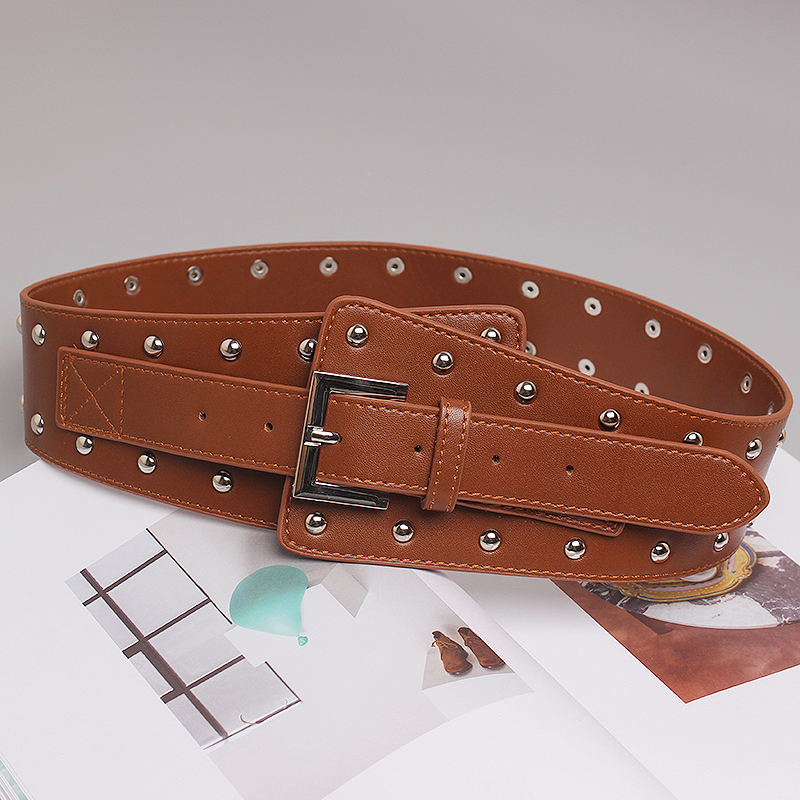 Trendy brown genuine leather rivet belt for women, perfect for various outfits and occasions.
