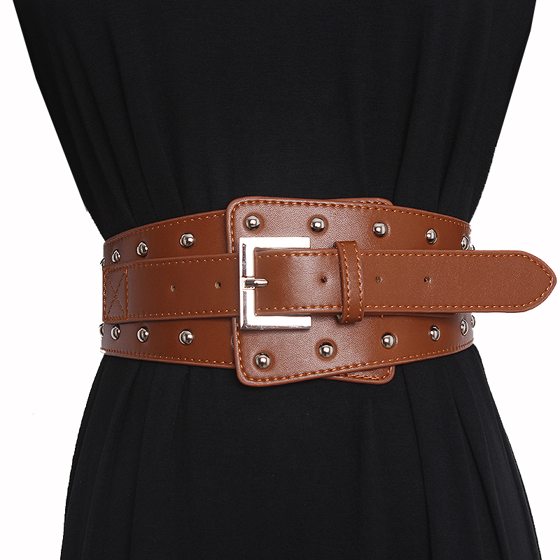 Fashionable wide genuine leather rivet belt for women, featuring a metal buckle and stylish rivets, perfect for various outfits.