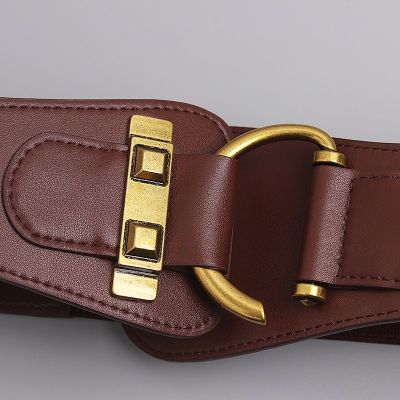 Close-up of a stylish brown leather belt featuring a big gold color pin buckle, perfect for enhancing any outfit.
