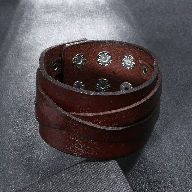 Wide leather bracelet with silver studs, featuring a punk style design for men and women.