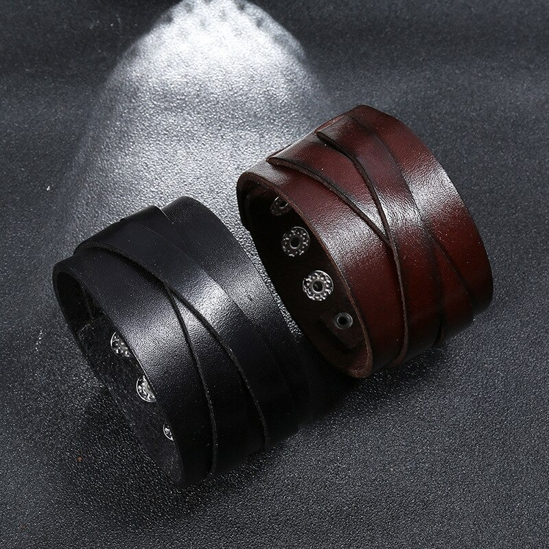 Two wide leather bracelets in black and brown, featuring a punk style design for men and women.