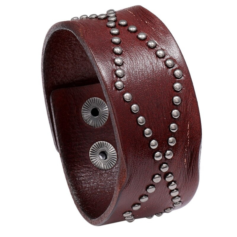 Wide vintage brown leather bracelet with silver rivets in punk rock style.