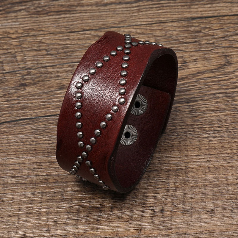 Wide vintage brown leather bracelet with silver rivets, perfect for punk rock style enthusiasts.