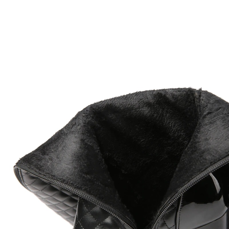 Interior view of stylish black knee high boots featuring soft fur lining and quilted exterior design.