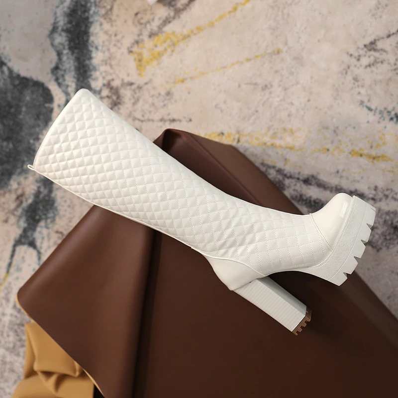 Stylish white high heel knee high boots made of PU leather, featuring a trendy quilted design and sturdy platform sole.