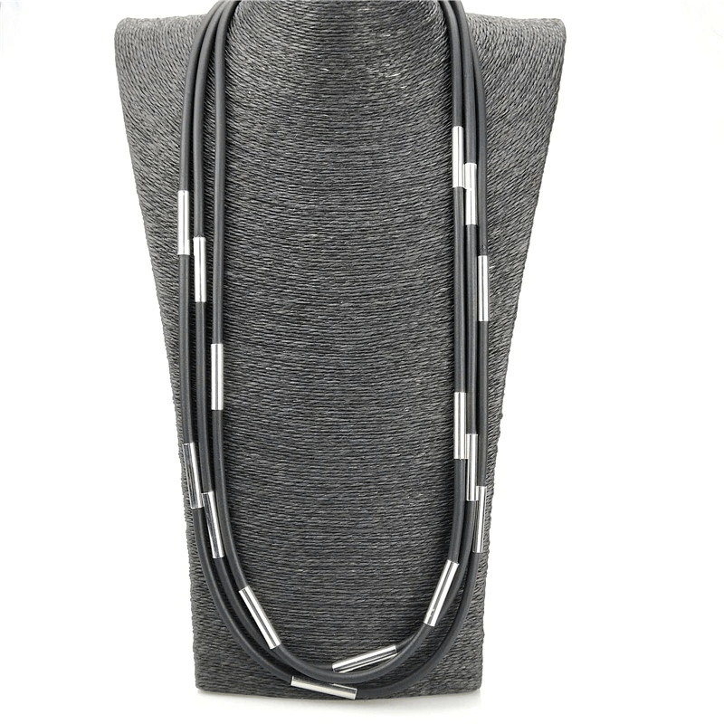 Handmade black rubber Gothic necklace with silver accents displayed on a gray bust.