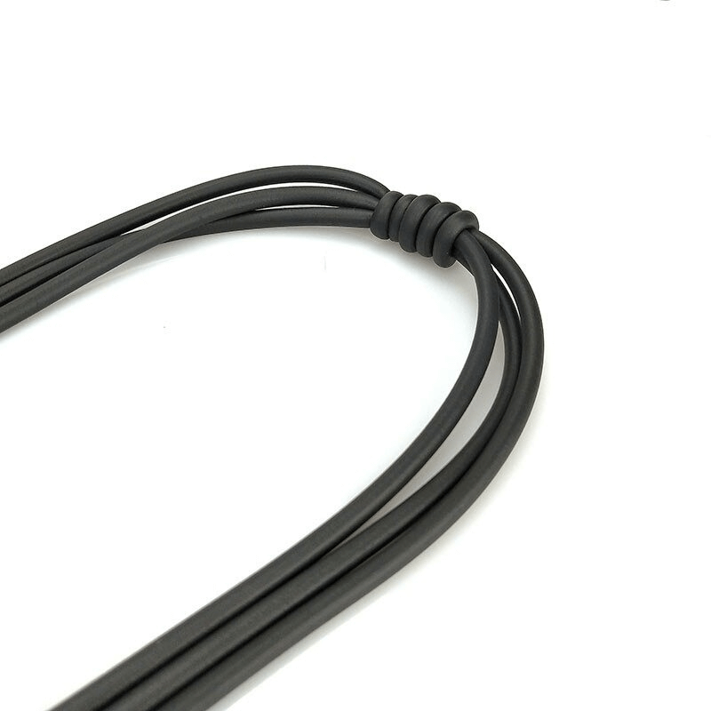 Close-up of a handmade black rubber necklace showcasing its gothic style and unique knot design.
