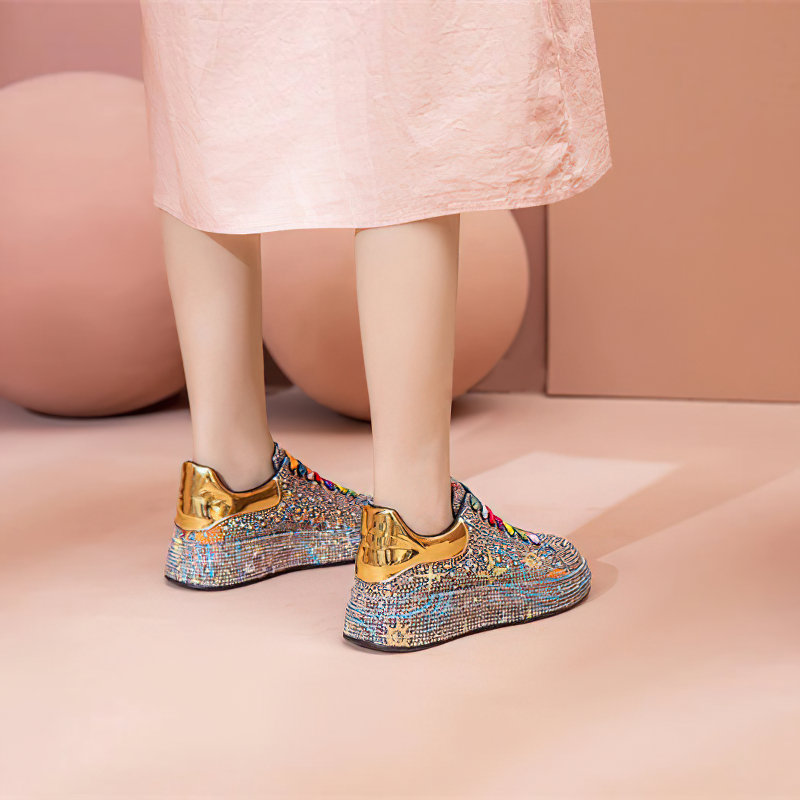 Stylish women's platform sneakers with shiny rhinestones and gold accents, perfect for standing out.