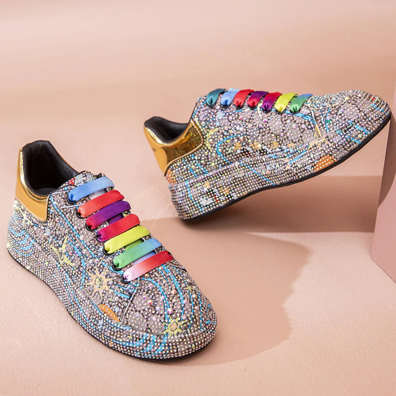 Shiny women's platform sneakers with colorful rhinestones and vibrant laces, perfect for a bold fashion statement.