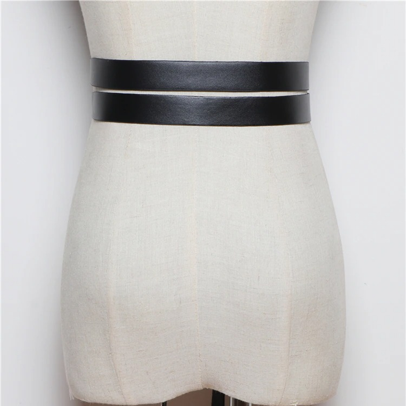 Fashion women's black PU leather belt displayed on a mannequin, elegant and versatile accessory for any outfit.