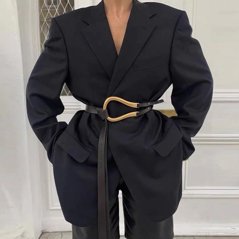 Trendy women's outfit featuring a black blazer cinched with a PU leather belt and gold metal buckle for a stylish look.