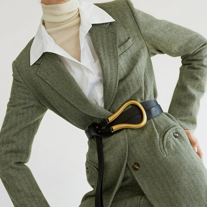 Fashionable woman in a vintage suit wearing a stylish PU leather belt with a gold buckle.