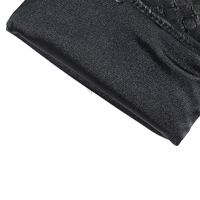 Close-up of luxurious black leather gloves featuring hand-woven sheepskin and a stylish Gothic design.