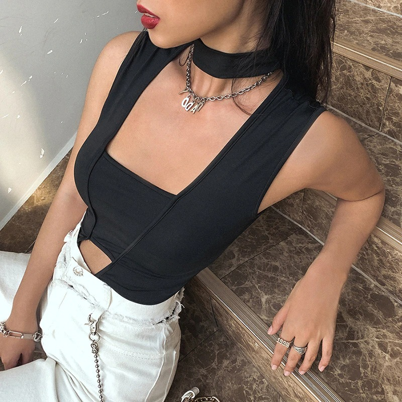 Fashionable woman in a black sleeveless top, showcasing casual style and chic accessories for a trendy look.