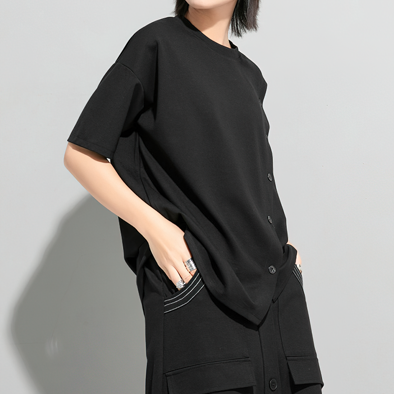 Stylish women's black T-shirt with buttons and half sleeves, featuring an asymmetrical design and relaxed fit.