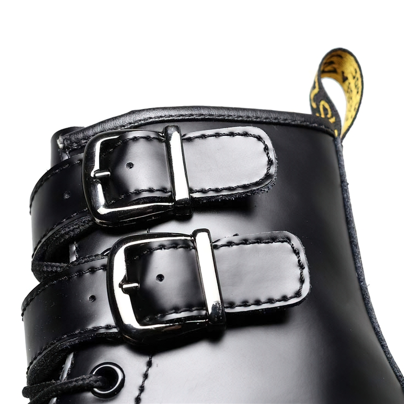Close-up of stylish black PU leather women's boots featuring buckle details and laces for comfortable wear.