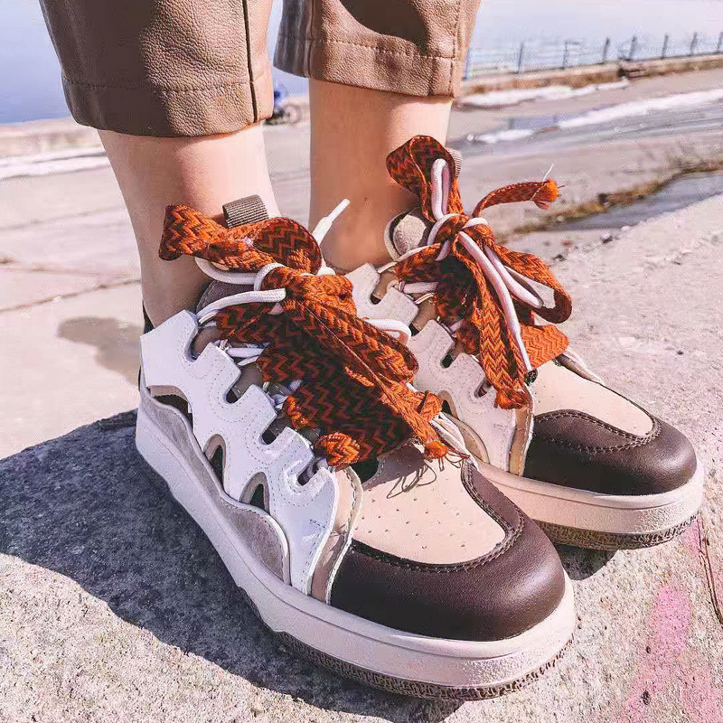 Stylish women's chunky platform sneakers with mixed color laces, perfect for retro fashion and casual outfits.