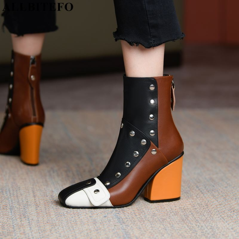 Fashionable women's high heel ankle boots in multicolor with rivets and a unique design.