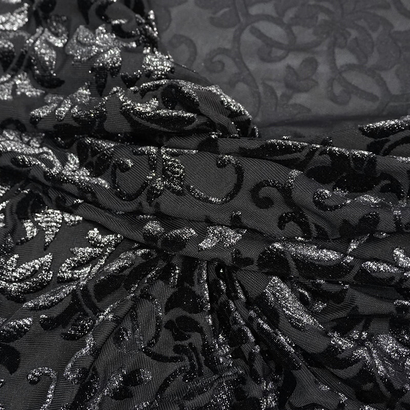 Close-up of elegant black fabric with intricate gothic floral patterns, showcasing the vintage style of a women's crop top.