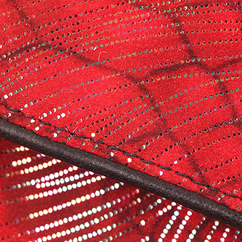 Close-up of elegant red fabric with shimmering details, showcasing style and texture for fashionable accessories.