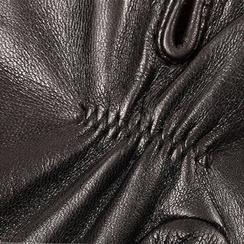 Close-up of exquisite lambskin leather texture, showcasing delicate stitching for elegant women's gloves.