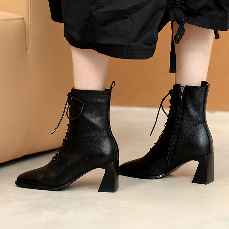 Fashionable women's ankle boots in black genuine leather with a block heel, perfect for casual outfits and stylish everyday wear.