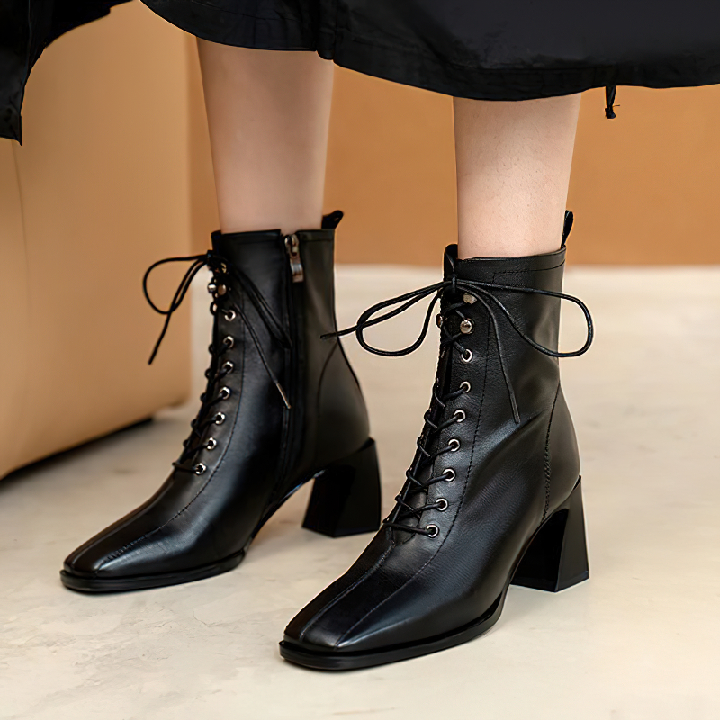 Chic women's black ankle boots made of genuine leather with lace-up design and stylish heel, perfect for casual outfits.