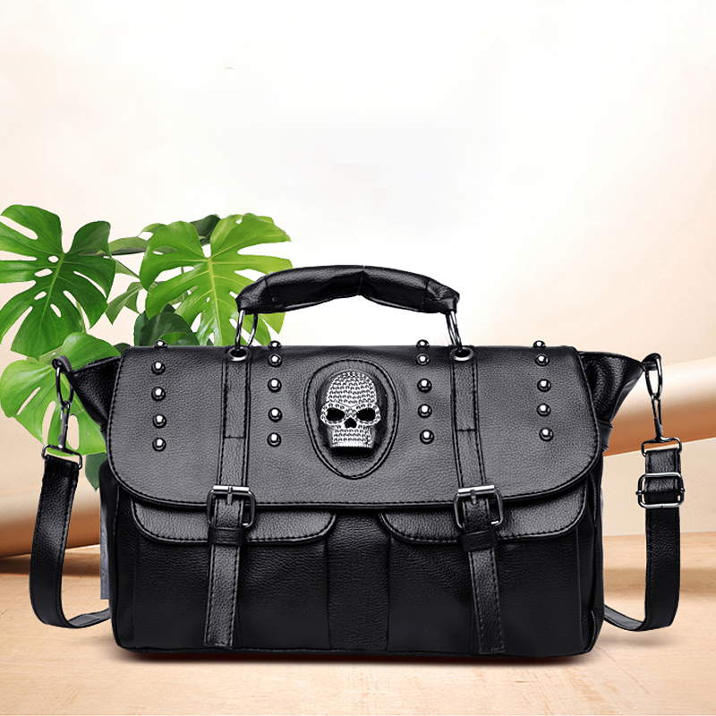 Trendy black PU leather handbag with skull design and rivets, features both shoulder strap and handles, perfect for daily use.