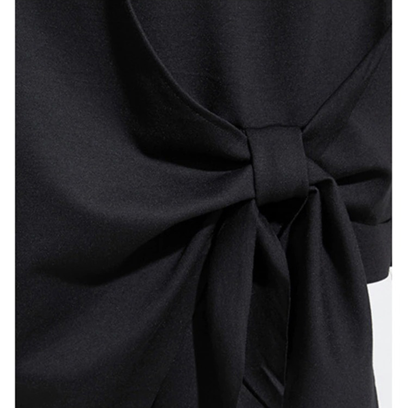 Close-up of a stylish black women's top featuring a chic tie detail, perfect for casual outings and comfortable wear.