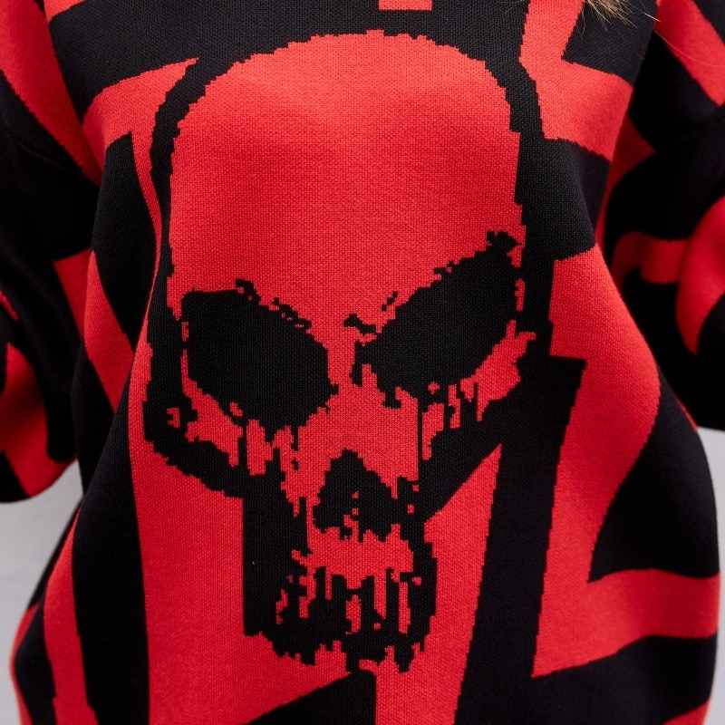 Close-up of a women's oversized knitting hoodie featuring a bold red and black skull print.